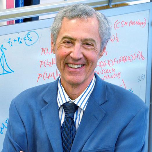 man standing in front of a whiteboard with scientific calculations on it
