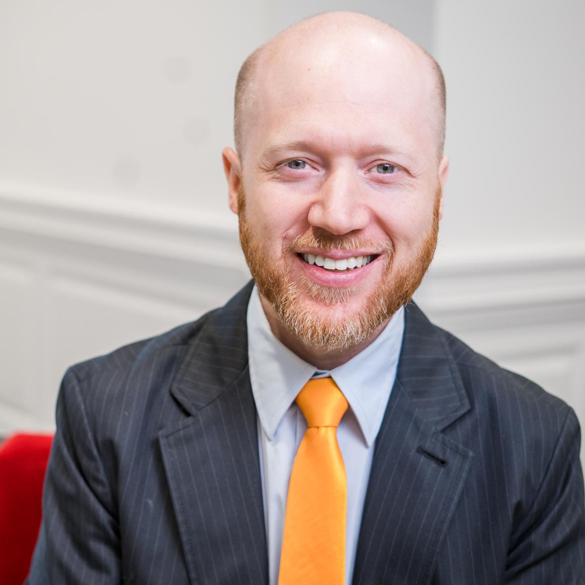man in a suit with a yellow tie