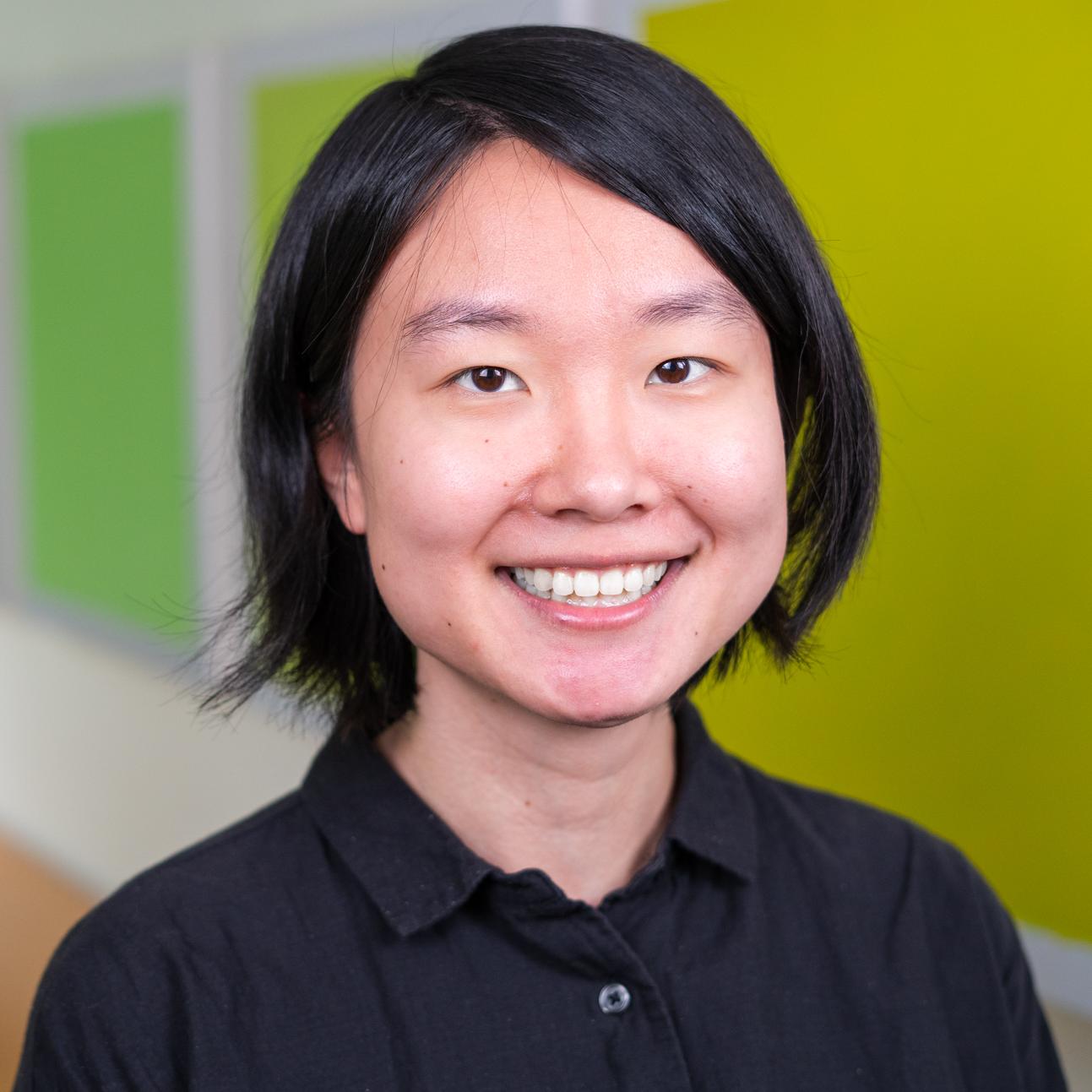person standing in front of bright green wall panels