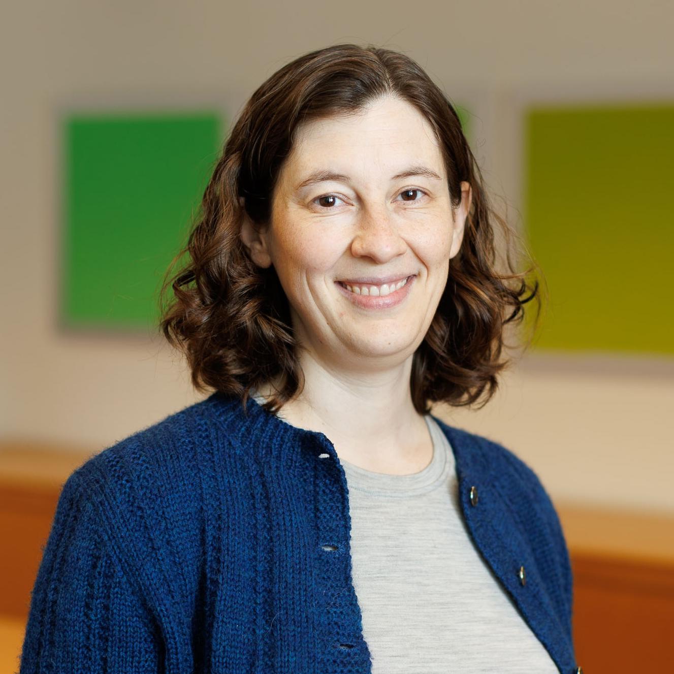 Portrait of Elizabeth Riley wearing a blue sweater