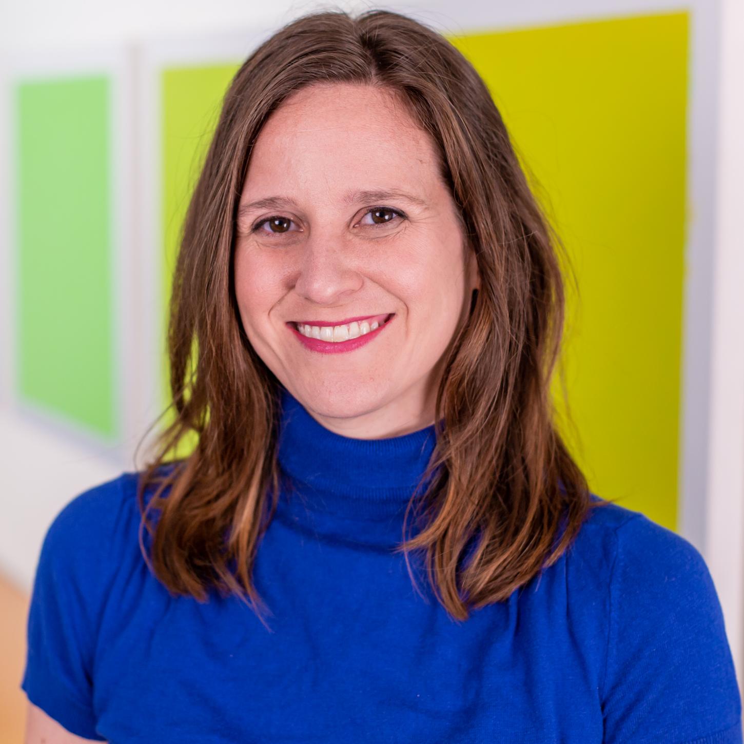 woman in a bright blue top and red lipstick