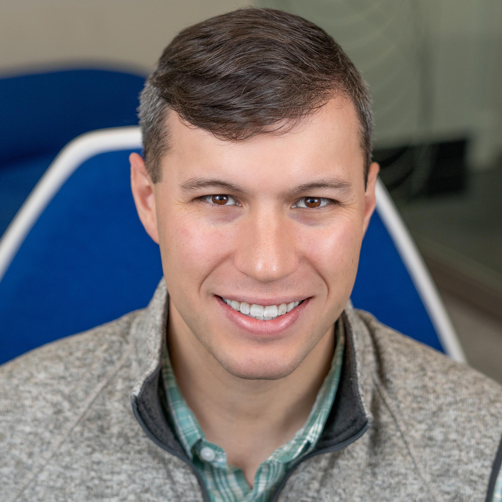 man sitting in a bright blue chair