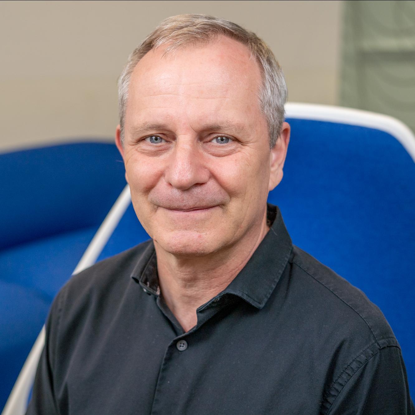 man sitting in a bright blue chair