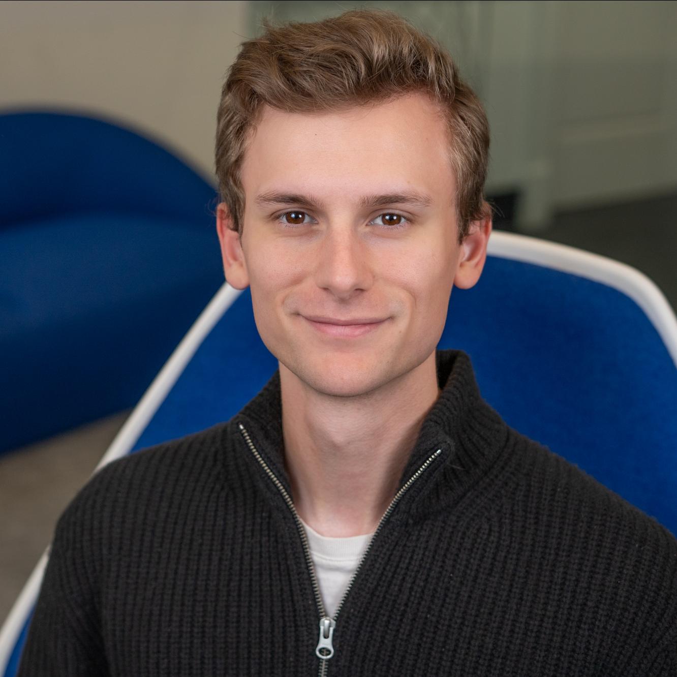 person sitting in a bright blue chair