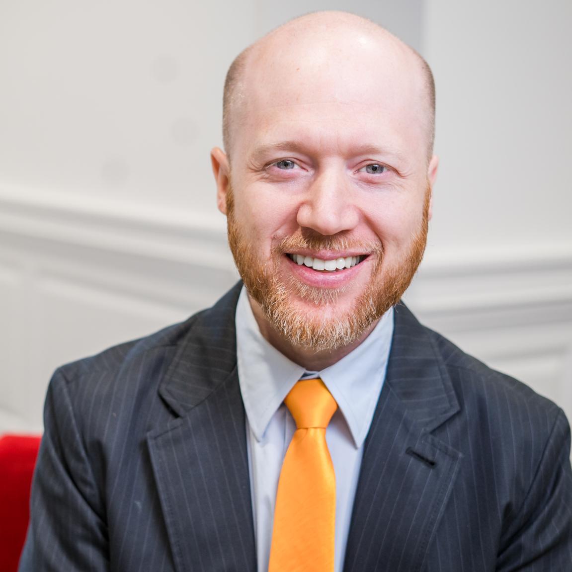 man in a suit with a yellow tie