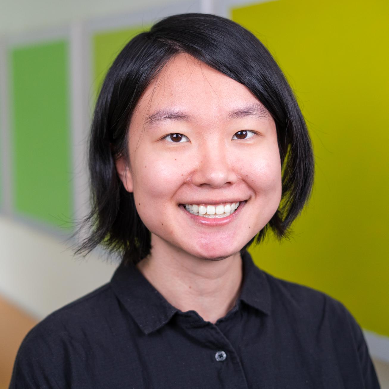 person standing in front of bright green wall panels