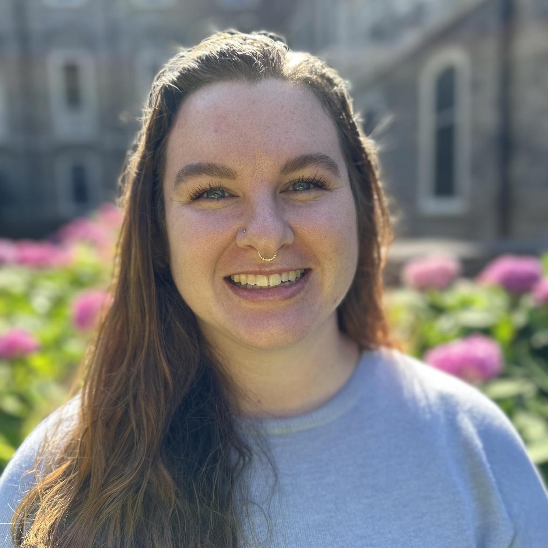 Leigh Ann Martin portrait in front of pink flowers