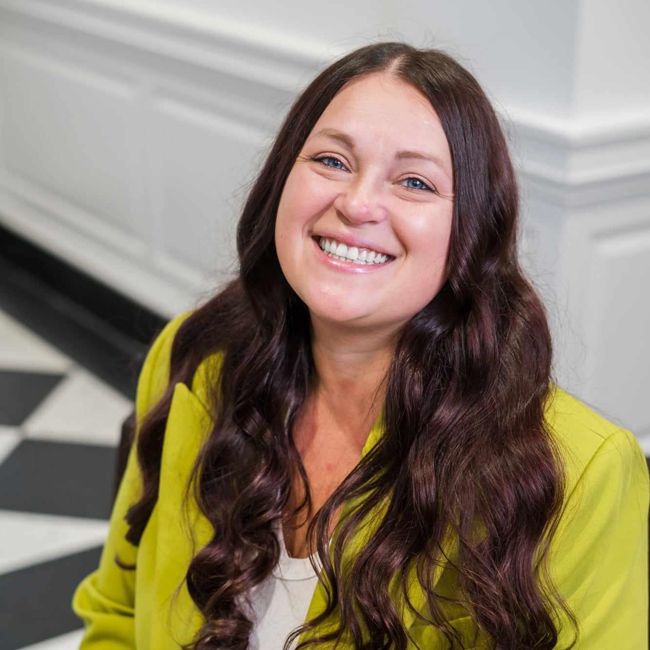 Portrait of Ksenia Lang wearing a green blazer