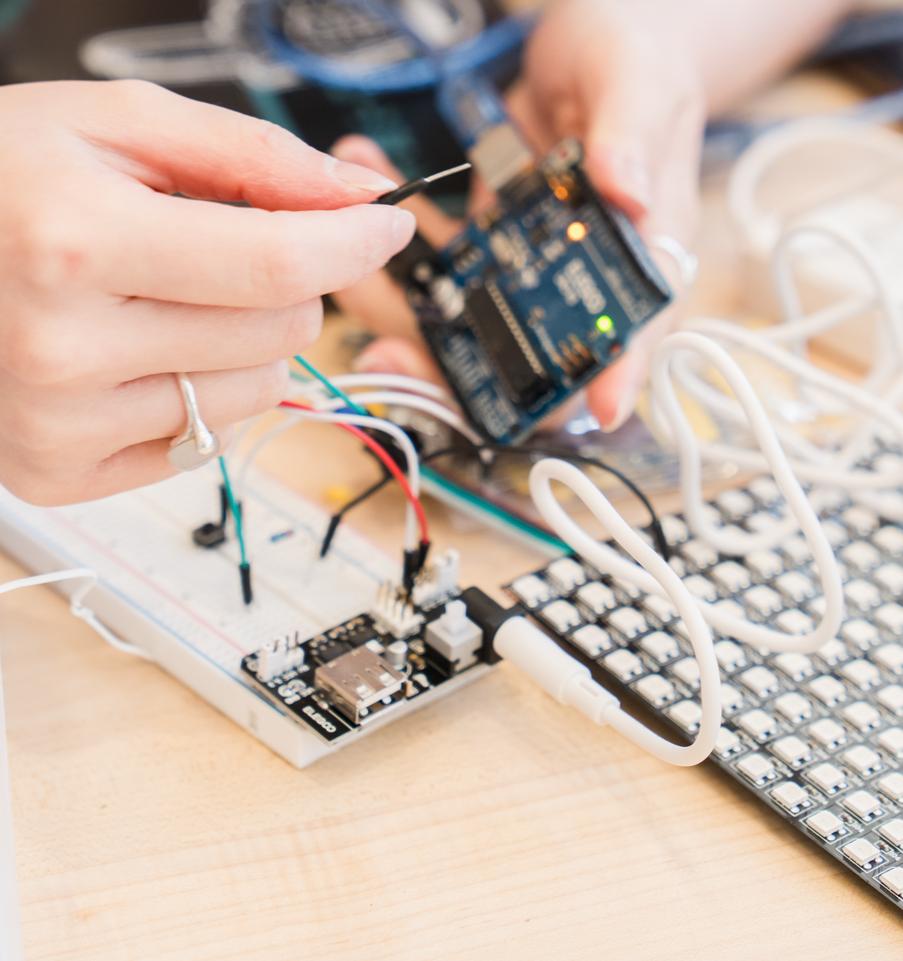 hands wiring an object
