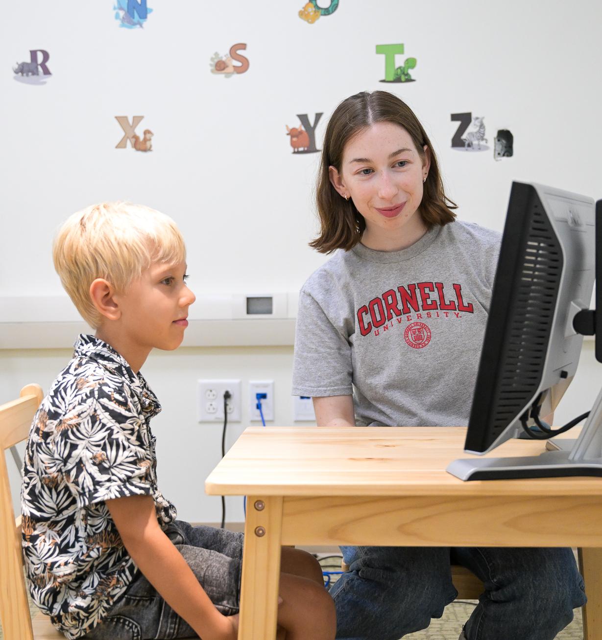 A student works with a child subject as part of a project studying how children develop morals