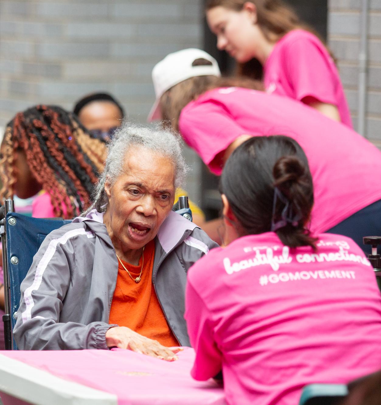 A student talks with an older woman at a community event
