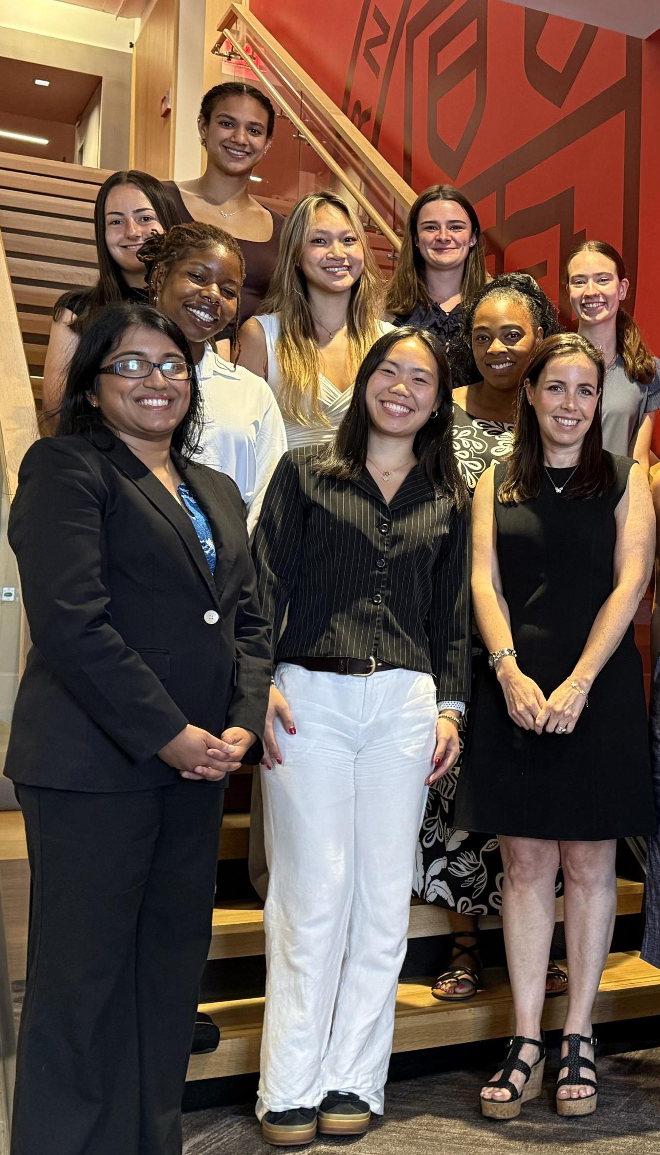 CHE in NYC interns standing on a staircase