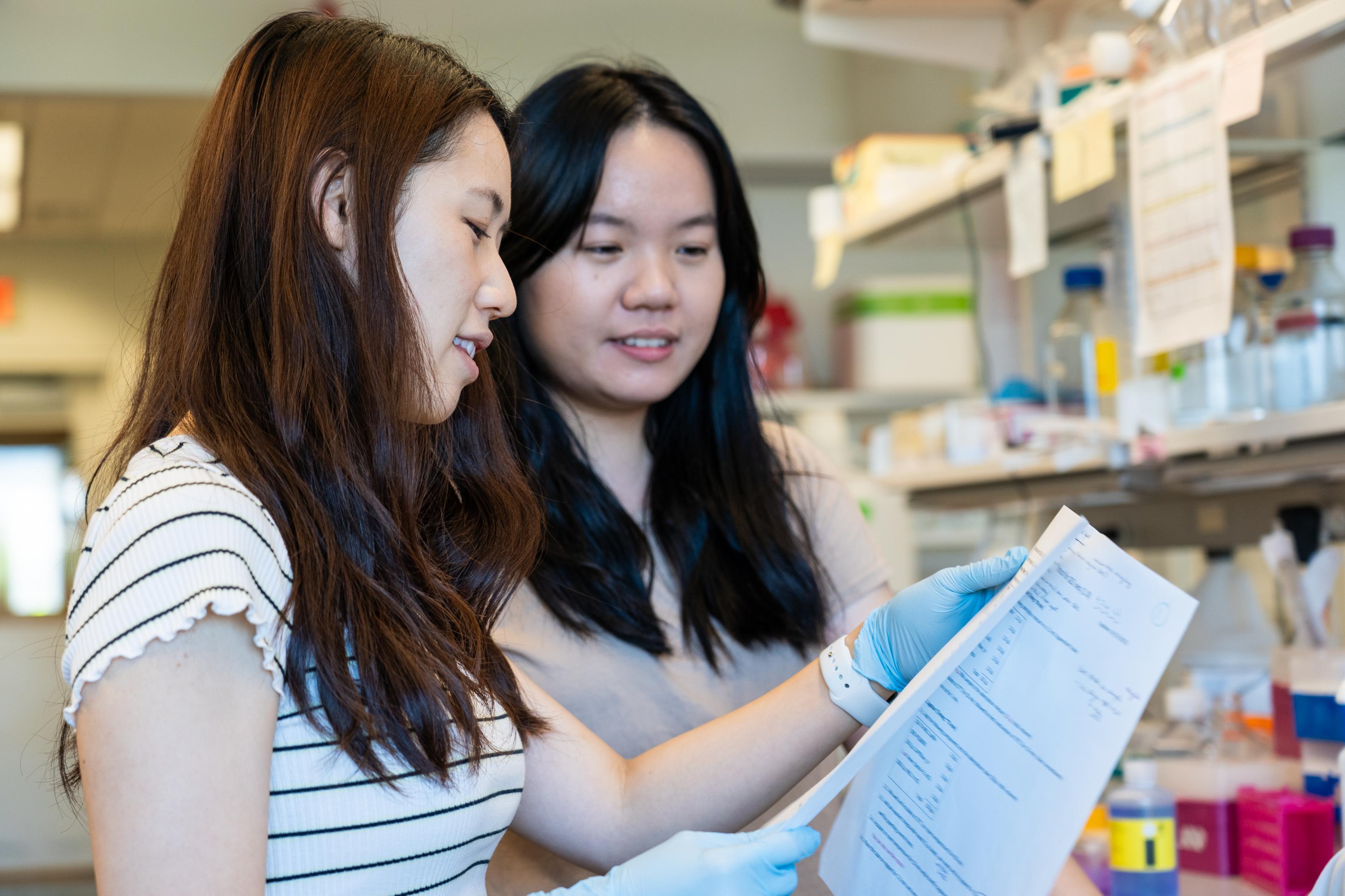 2 students study lab results 