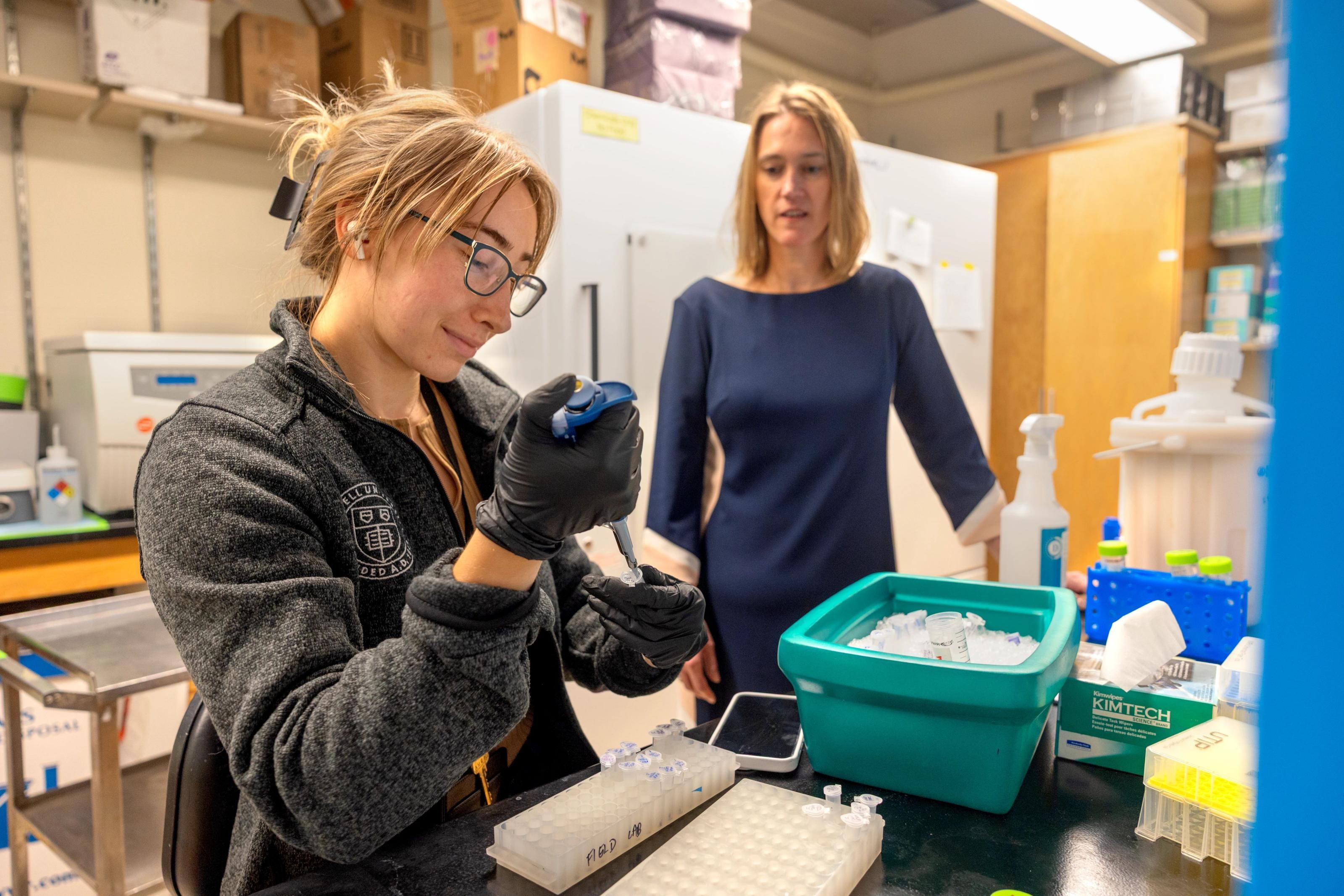 Chloe Purcell and Dr. Martha Field work in a lab.