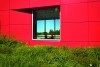 a modern red building with a square window