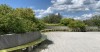 curving outdoor bench along a patio with blue sky and white clouds