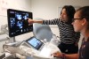 women looking at ultrasound results on a screen