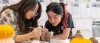 Two students with a clay printer