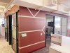 office interior with a red and white accent wall and cubicles