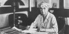 Martha Van Rensselaer at desk