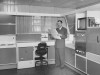 Glenn Beyer stands in the Cornell Kitchen and looks at architectural plans