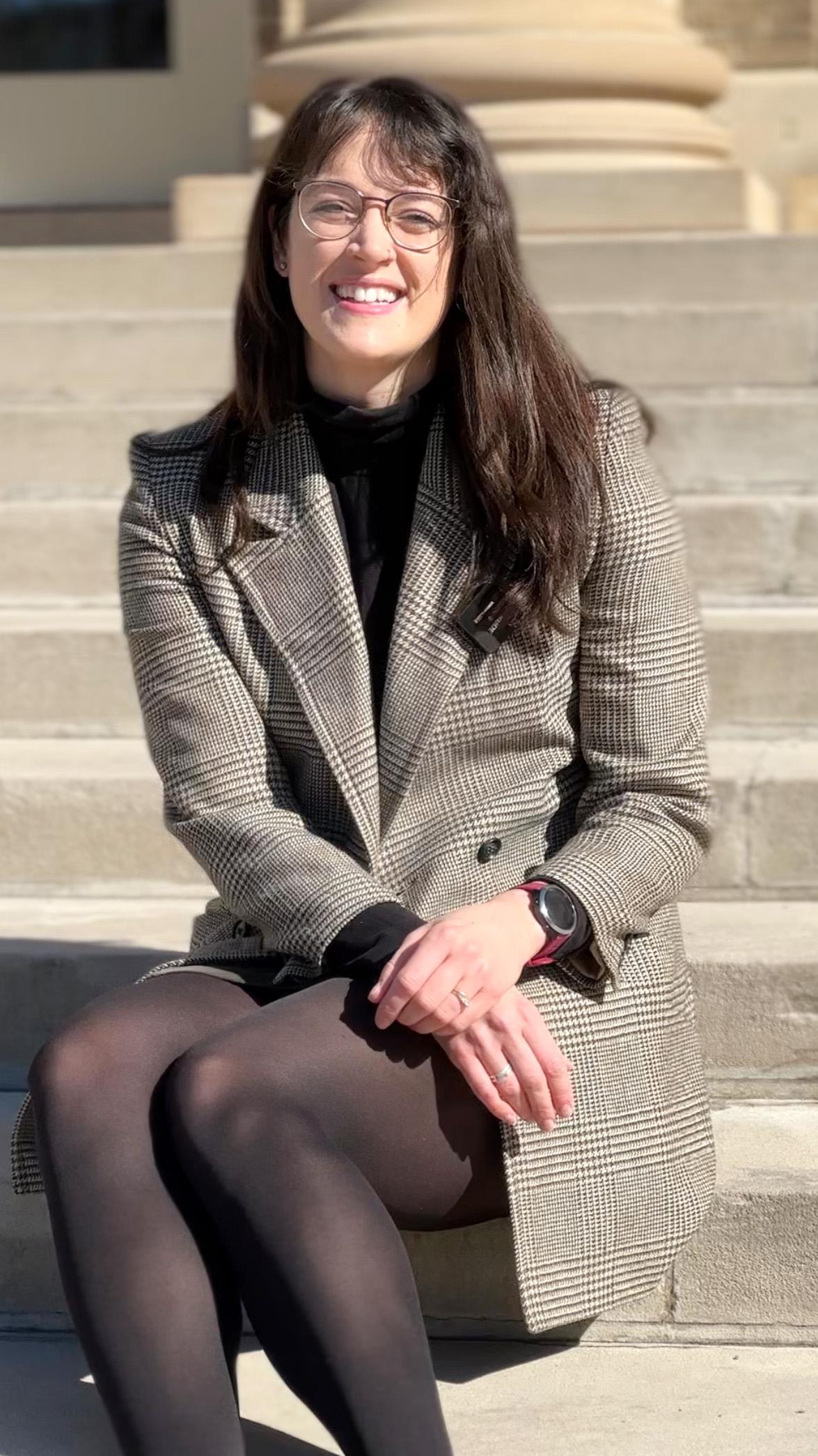 Kathleen McCormick sitting on a set of stairs