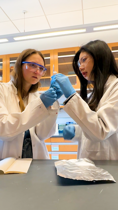 Students examining nanofibers in lab