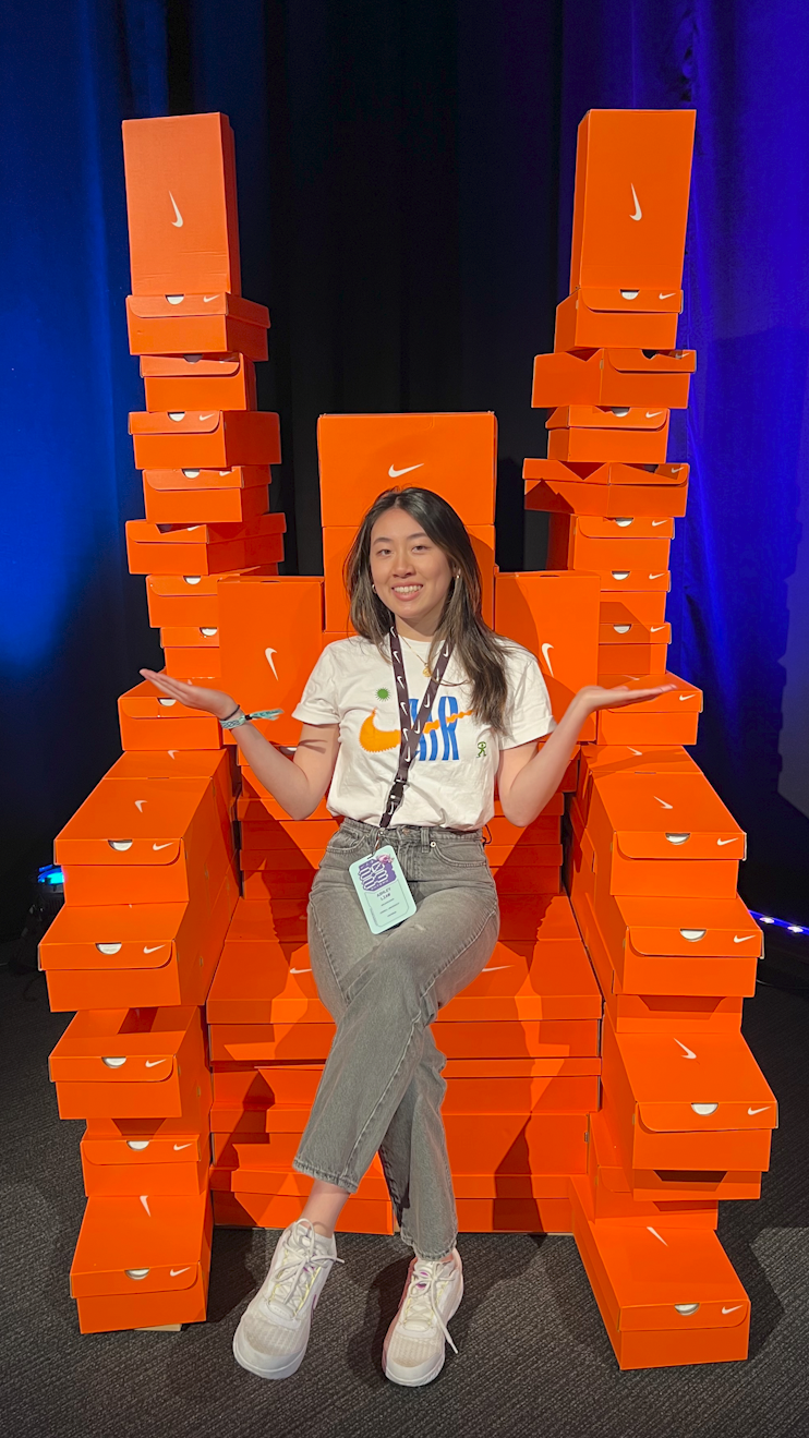 Ashley Liaw sitting on chair constructed out of Nike shoe boxes