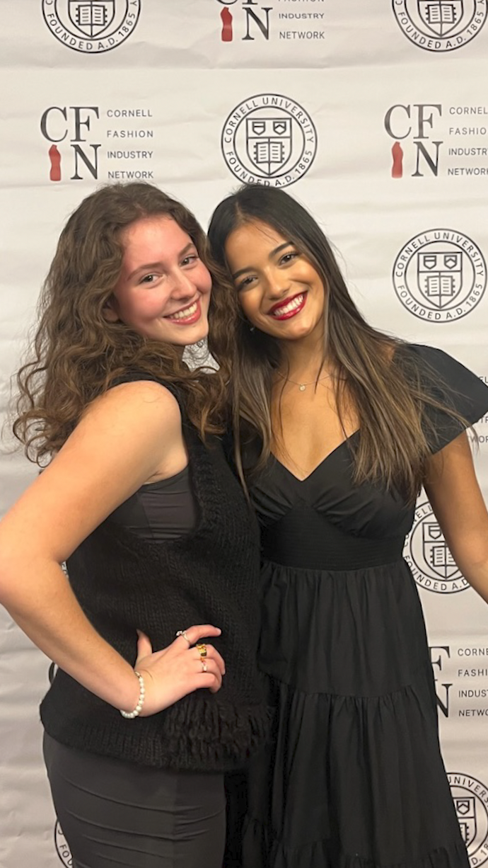 Students posing in front of a step-and-repeat