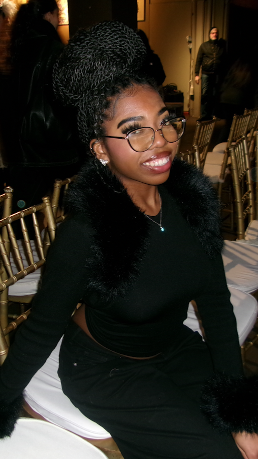 Eskyla Chesson sitting in a chair at NY Fashion Week